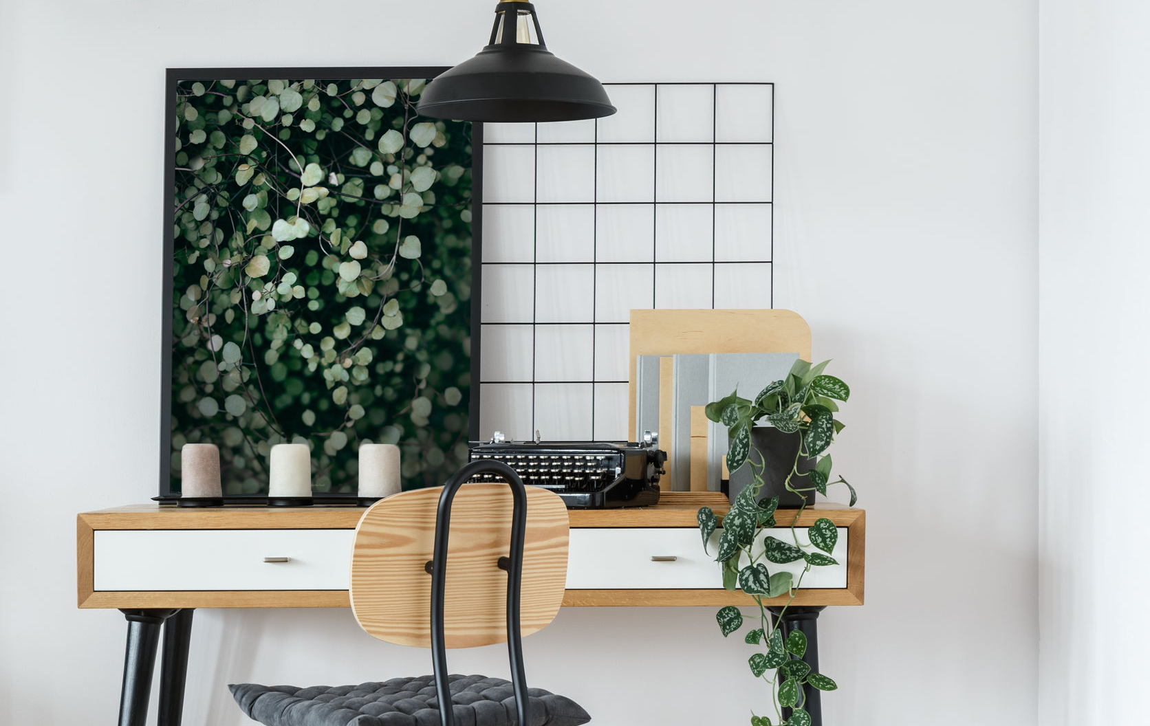 93191281 - modern retro style desk and chair in cozy white home office interior with vintage typewriter, plant and poster